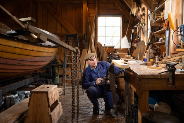 istock Senior wooden boat builder at traditional boat yard 1322728809