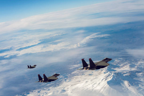 istock Jet fighters flying over snowcapped mountains. 1322728984