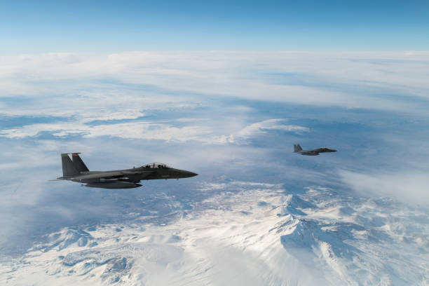 istock Jet fighters flying over snowcapped mountains. 1322729922