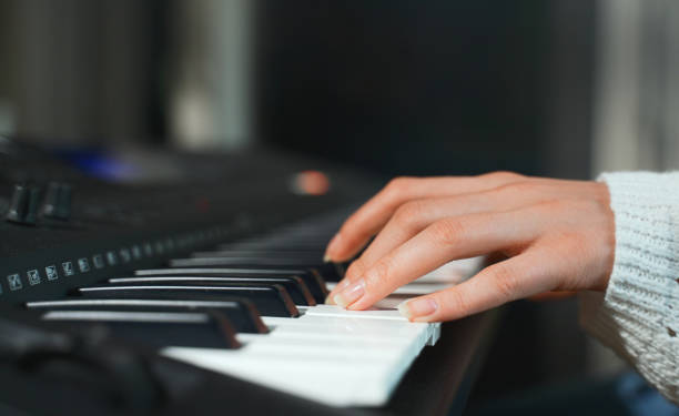 istock Girl playing piano. Close-up view. 1322731232