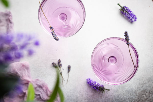 Purple cocktail drink Purple cocktail drink in a glass on white background with flowers, top view Gin stock pictures, royalty-free photos & images