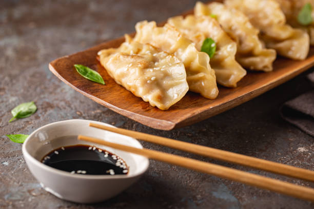 istock Asian dumplings with soy sauce 1322731598
