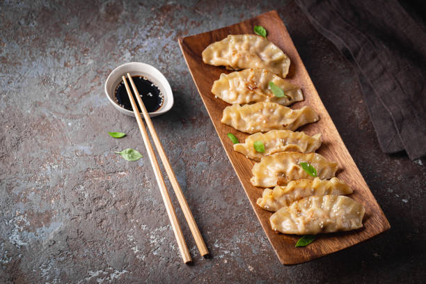 istock Asian dumplings with soy sauce 1322731600