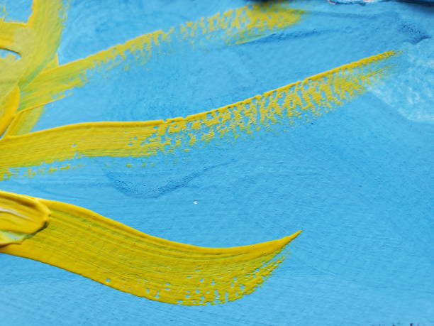 istock Yellow sunbeams on blue background artwork created by brush paint strokes on paper texture 1322731847