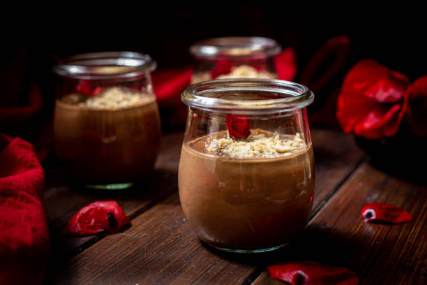 istock Nougat pudding on a wooden table with red poppy flowers front view 1322733231