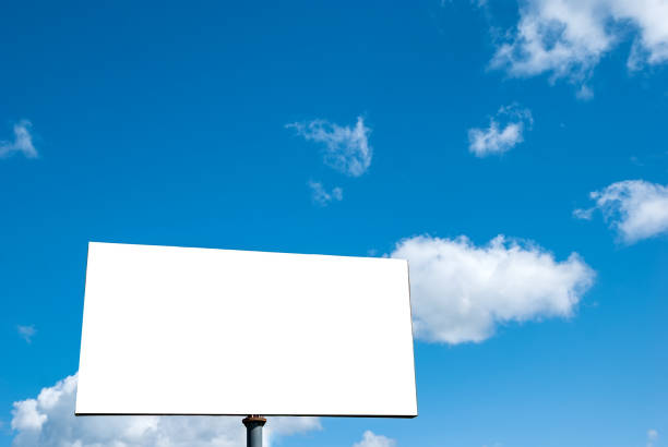 istock White tabloid against a blue sky with beautiful clouds. 1322734794