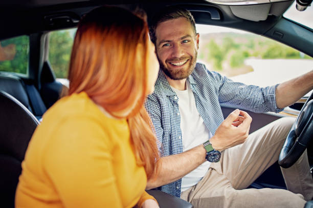 istock Couple driving a car and having fun 1322735342