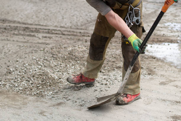 istock Work with a shovel at a construction site. A worker throws cement and gravel with a shovel. 1322736543