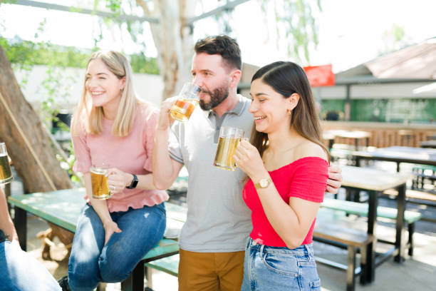 istock Beautiful couple having drinks with friends 1322737259