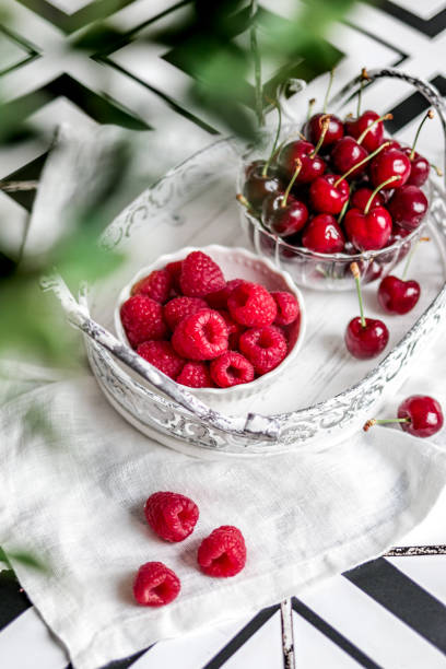 istock Summer fruit Berries in bright kitchen with Raspberries and cherries 1322737493