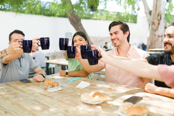 istock Young women and men drinking hot coffee 1322737581