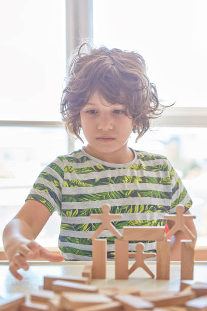 istock Cute little boy Playing with Wooden Blocks 1322737743