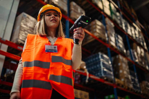 istock Young woman scanning boxes in warehouse 1322738642