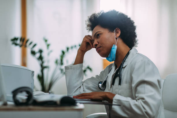 istock Afro doctor working on laptop in medical office 1322739232