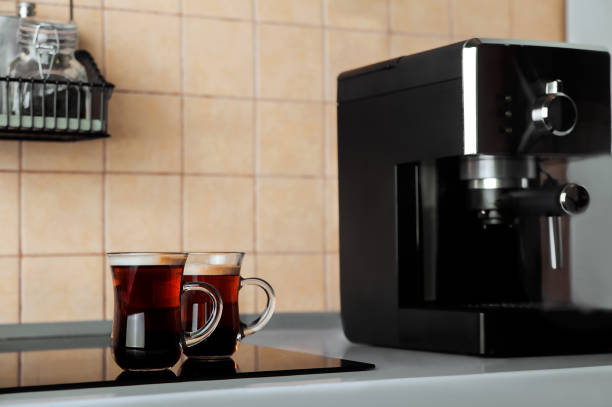 istock Two transparent cups coffee close-up front view. Home coffee maker and process of making coffee drink. Copy space. 1322739932