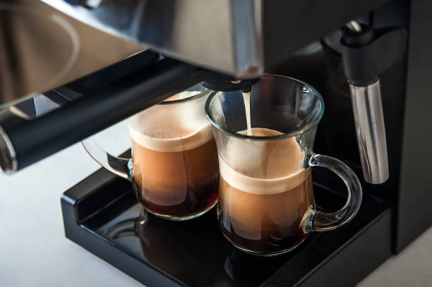istock Two transparent cups coffee close-up front view. Home coffee maker and process of making coffee drink. Copy space. 1322739944