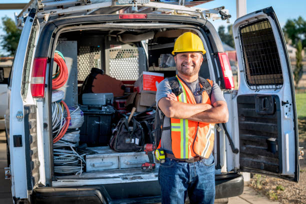 istock Smiling hispanic construction worker wearing a work helmet looking at the camera 1322740061
