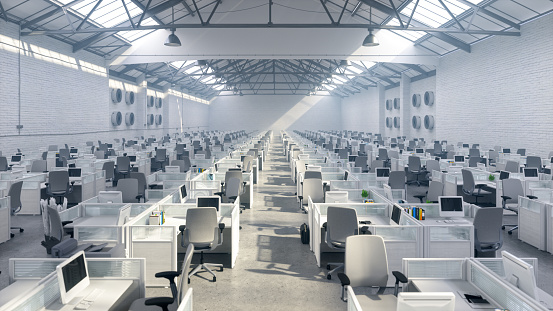 Empty large call center with cubicles in a warehouse.