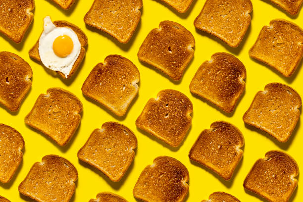 istock Fried bread until golden brown, scrambled eggs for breakfast. Crunchy carbs on a bright yellow background. Top view. 1322741306