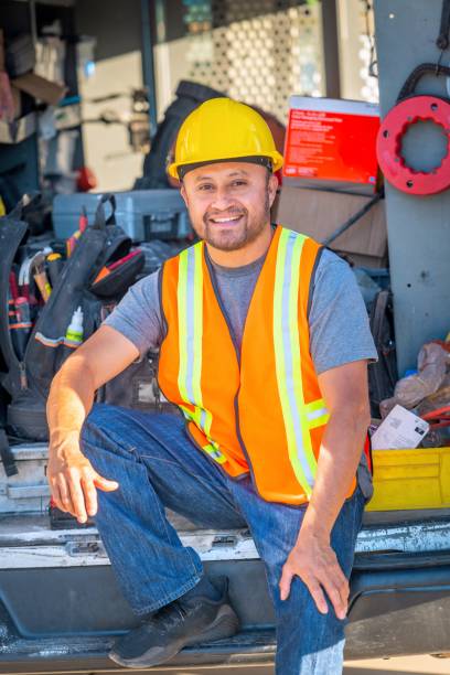 istock Smiling hispanic construction worker wearing a work helmet looking at the camera 1322742116