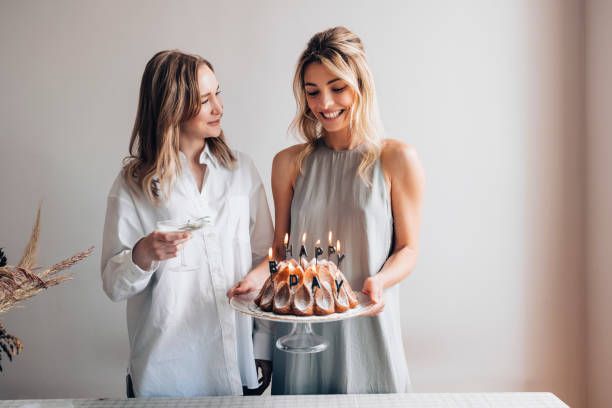 sister love: due donne sorridenti che festeggiano un compleanno insieme - birthday family party cake foto e immagini stock