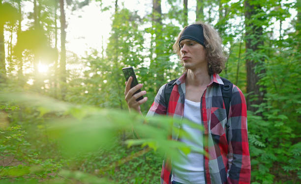 Man with smartphone lost in the forest. Man with smartphone lost in the forest. no signal stock pictures, royalty-free photos & images