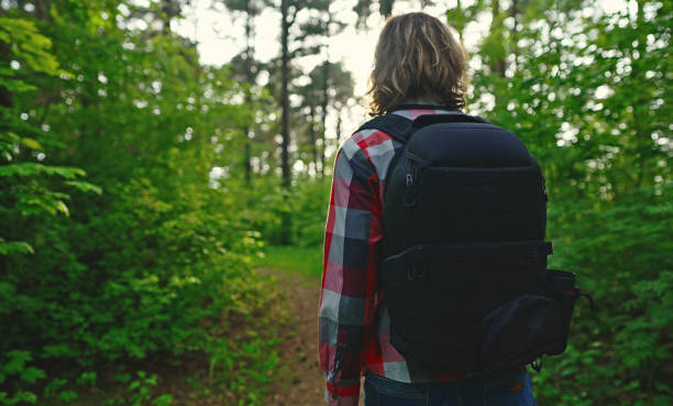 istock Man with backpack and sunglasses in the woods. Arc shoot. 1322742363
