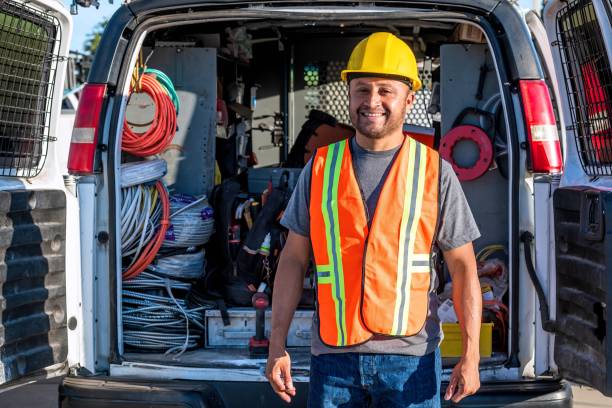 istock Smiling hispanic construction worker wearing a work helmet looking at the camera 1322742567
