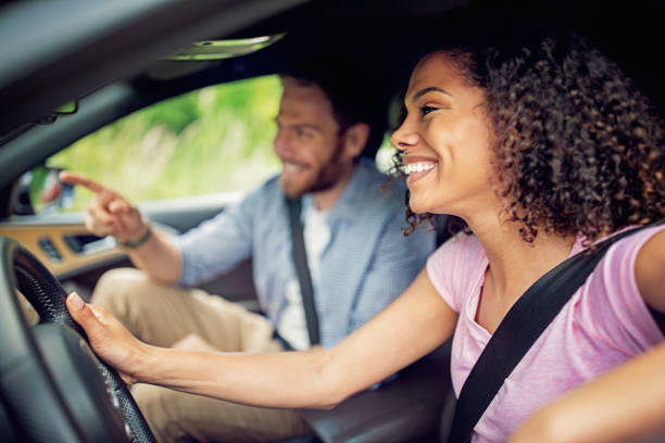 istock Couple driving a car and looking for direction 1322744783