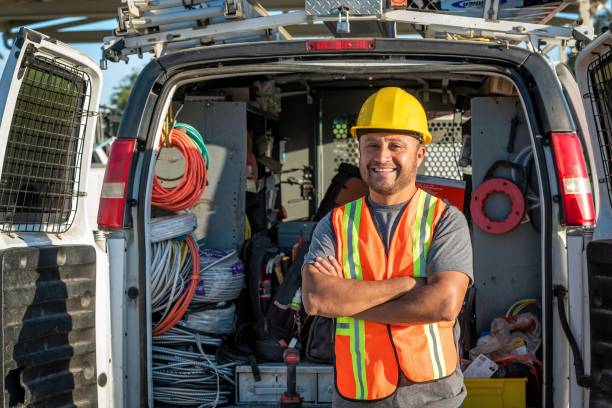 istock Smiling hispanic construction worker wearing a work helmet looking at the camera 1322746643