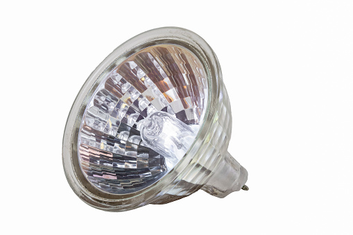 Halogen bulb in plastic housing. Accessories for illuminating the space in the household. Isolated background.