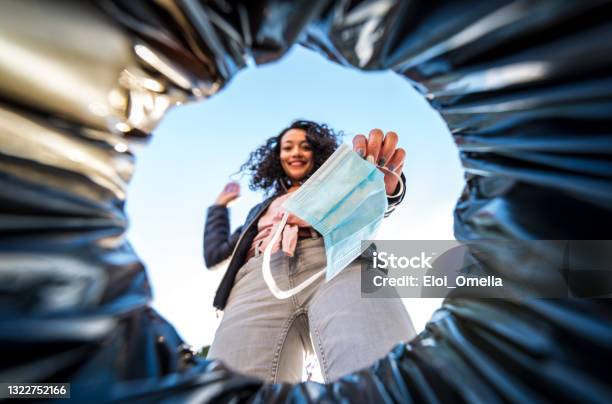 Woman Throwing Used Protective Surgical Mask Into The Garbage Bin From Inside Stock Photo - Download Image Now