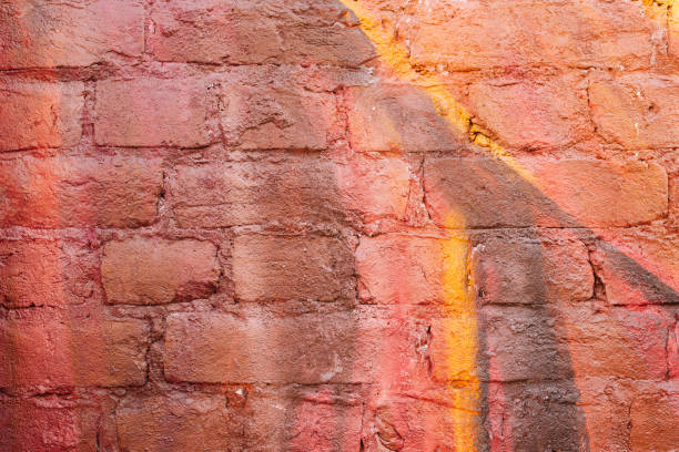 istock Multi-colored brick wall in vibrant burgundy and yellow colors 1322753131
