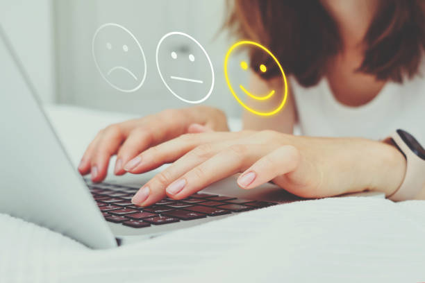 Good mood concept made of emoticon and rating. The girl puts grades on the Internet using a laptop. Good mood concept made of emoticon and rating. The girl puts grades on the Internet using a laptop armed forces rank photos stock pictures, royalty-free photos & images