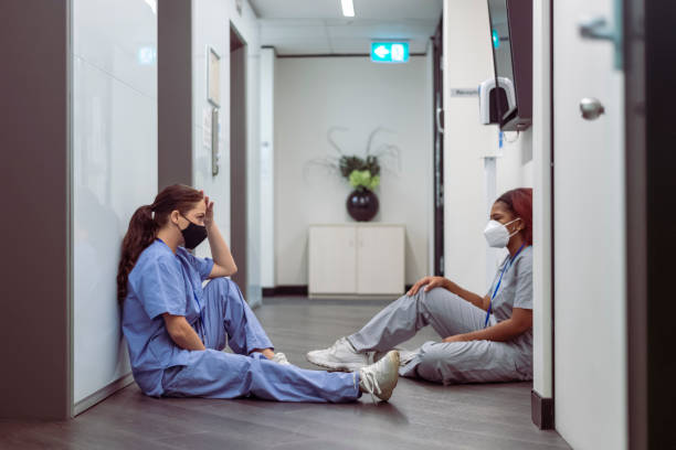 istock Two nurses comfort each other during COVID-19 pandemic 1322753243