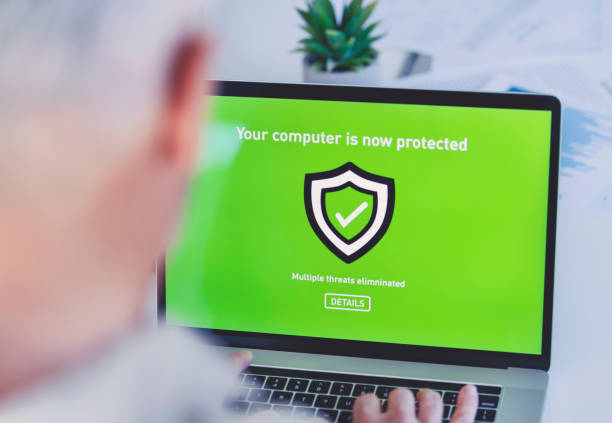 mature businessman looking at a antivirus security log in screen on a computer. - antivirus software fotos imagens e fotografias de stock