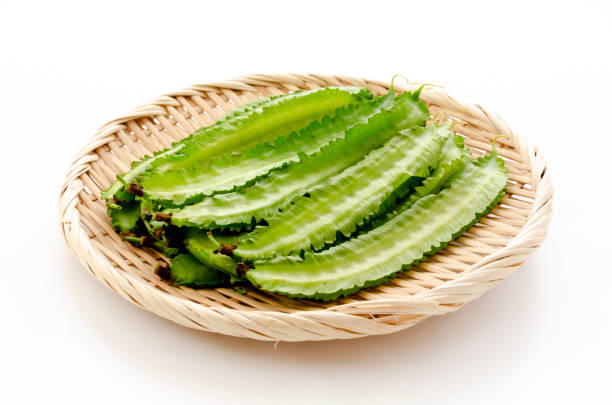 istock Fresh Winged beans on a bamboo sieve on a white background 1322763198