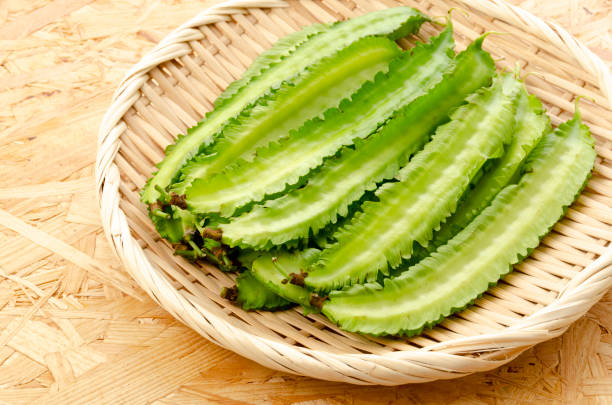 istock Fresh Winged beans on a bamboo sieve on a plywood Board background 1322763900