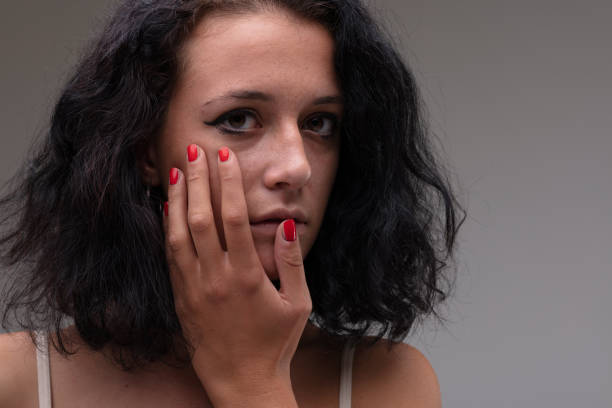 istock Serious soulful young woman holding her hand to her cheek 1322764708