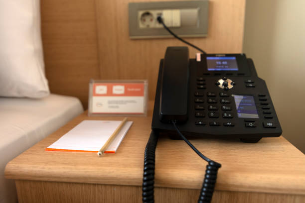 istock Black telephone and note in front and bed in the background 1322770809