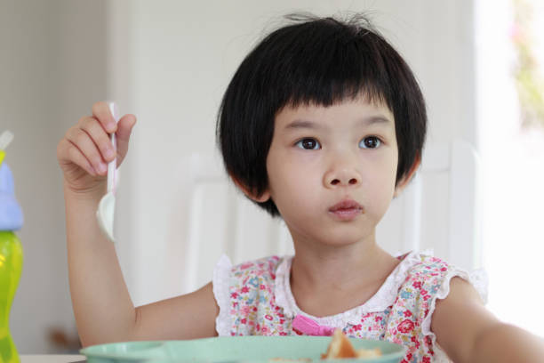 istock Little asian girl having breakfast 1322770825