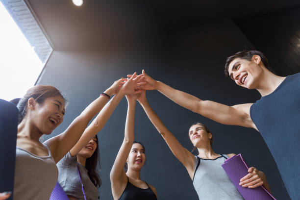 istock A Group of various young sporty people standing against the wall. Students taking a rest from fitness activity, waiting for a lesson to start, close up. Healthy lifestyle concept 1322778093