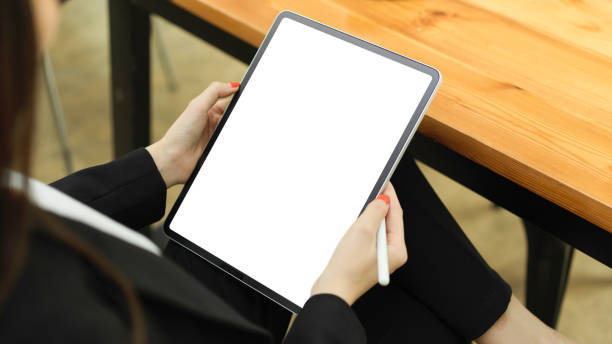 istock Businesswoman working with digital tablet while sign in cafeteria 1322779276