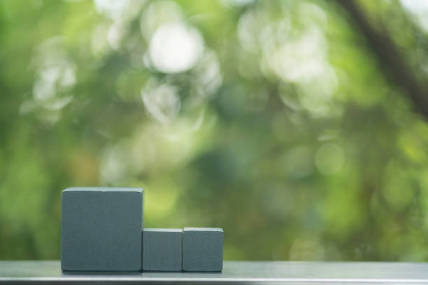 istock Empty gray wood block on table against nature background. 1322783225