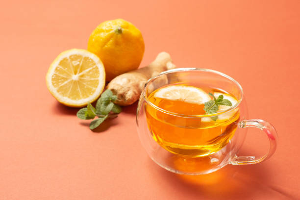 istock Ginger tea with mint and lemon. Healthy drink. Crystal cup on bright background. Selective focus. 1322785989