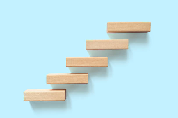 istock Growth or increase design concept. Cube block staircase moving step growing up to target. Success achievement or goal business motivation 1322786094