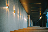 corridor of all movie theater hall with electronic wall light and carpet