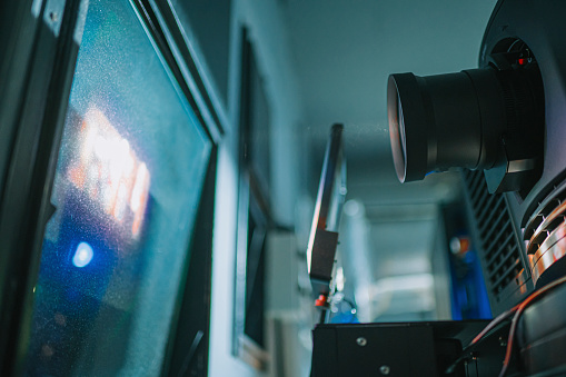 Blurry image of making movie video in big production studio and film crew team shooting or recording by professional digital camera and lighting set equipment.