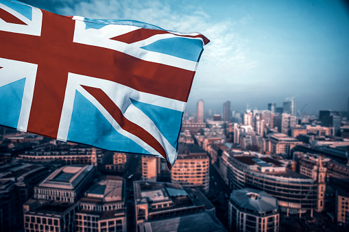 Union Jack flag and iconic London landmarks in the background