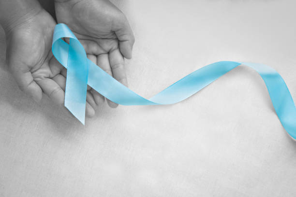 istock Hand holding Light blue color ribbon on white isolated background with copy space. Lymphedema and Prostate Cancer Awareness month symbol. Healthcare medical and insurance concept. Male cancer. 1322792114